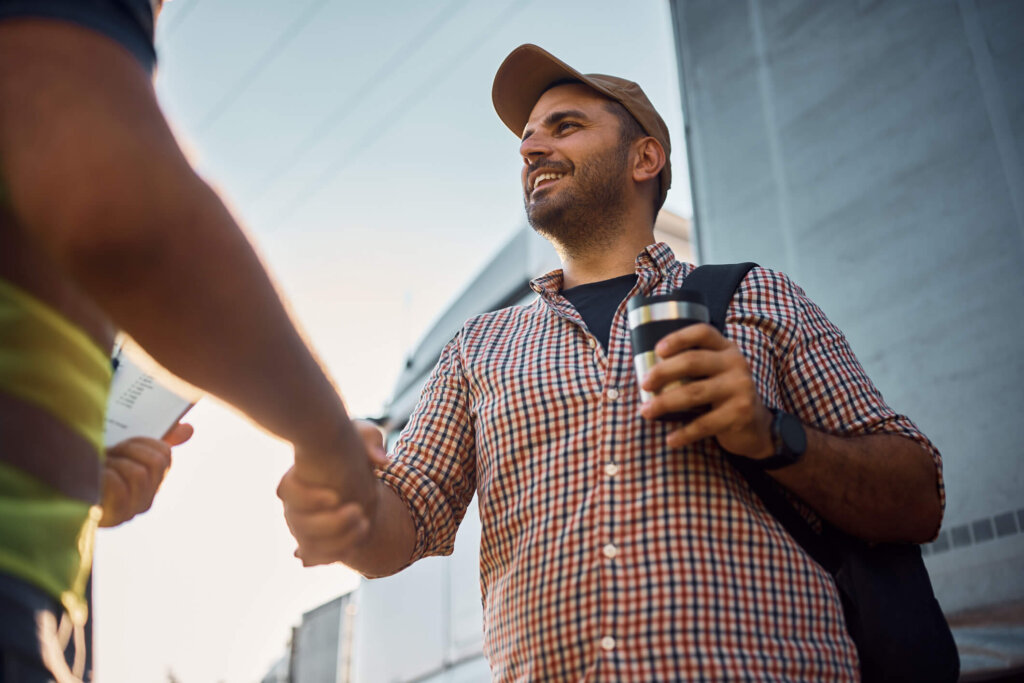 A rental property owner shaking hands with his trusted property manager in Houston. 