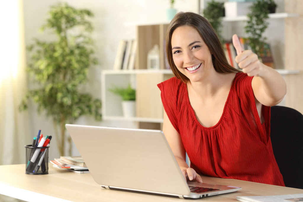 Female Willobrook tenant gives thumbs up as she puts in a maintenance request online