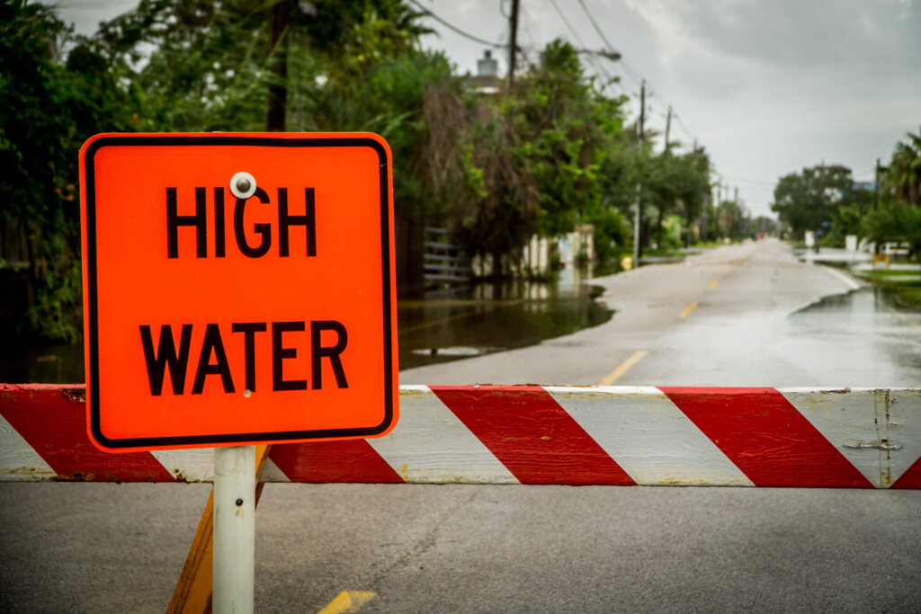 A high water sign blocks a flooded road in Houston.