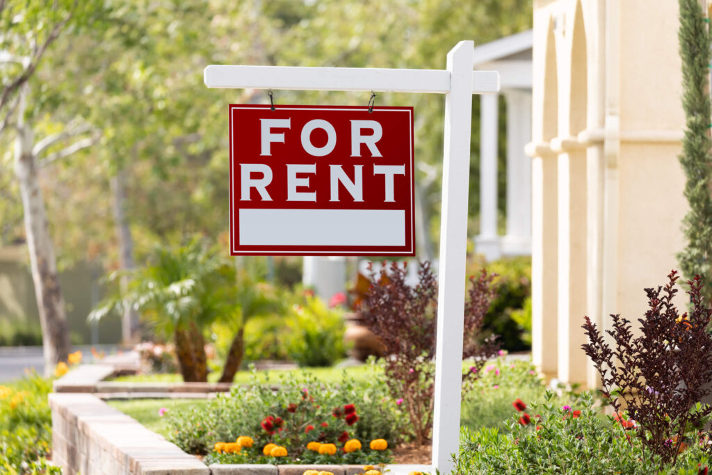 A For Rent sign in front a house in Conroe, TX 